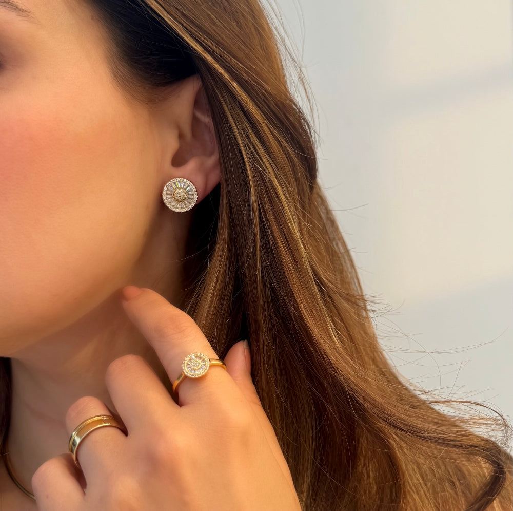 Woman wearing gold plated knot earrings with sparkling cubic zirconia