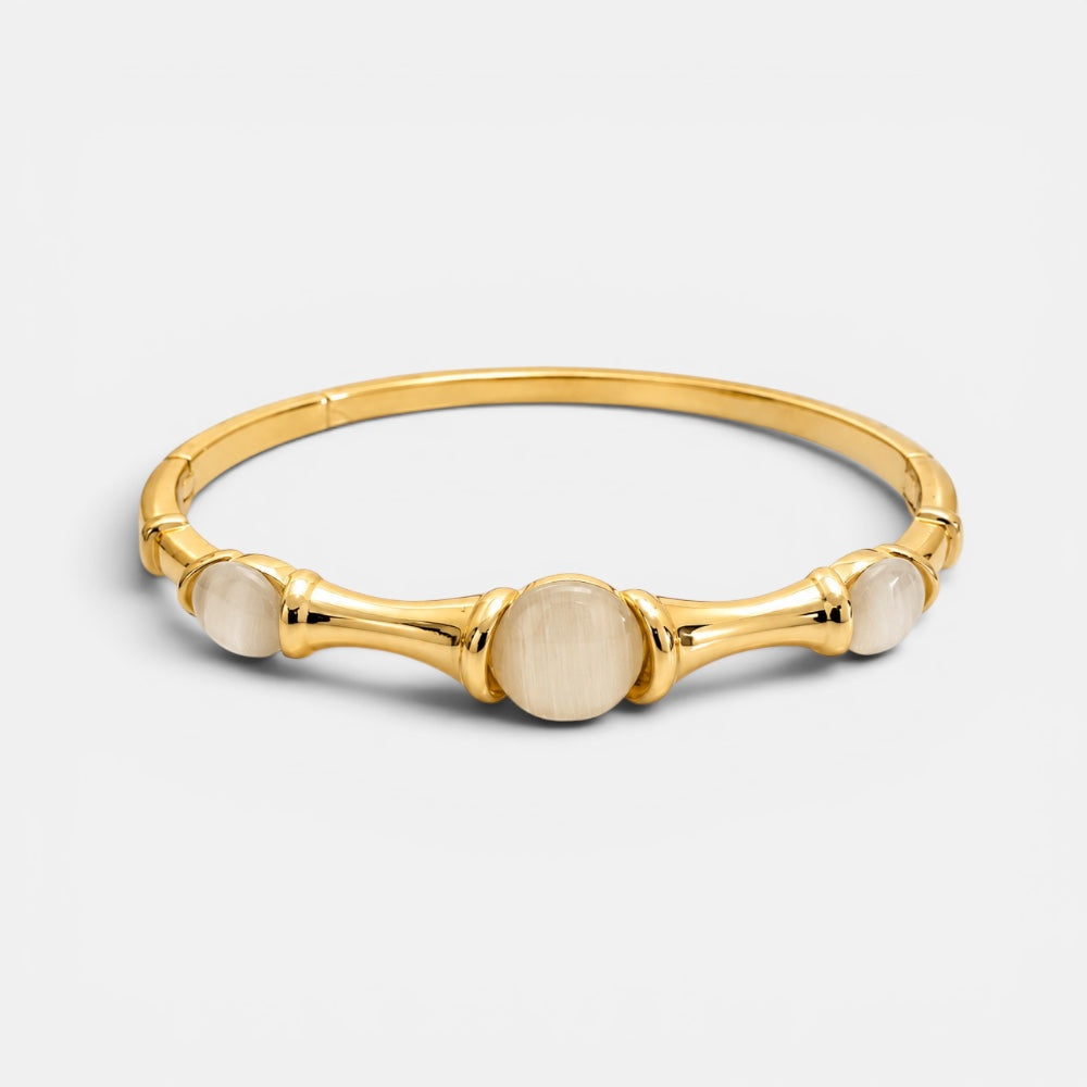 Gold plated bangle with luminous cat eye stone