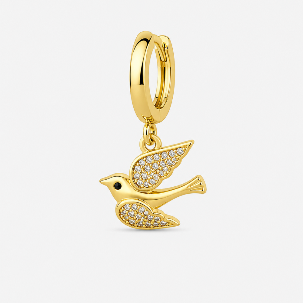 Gold plated peace dove charm on white background
