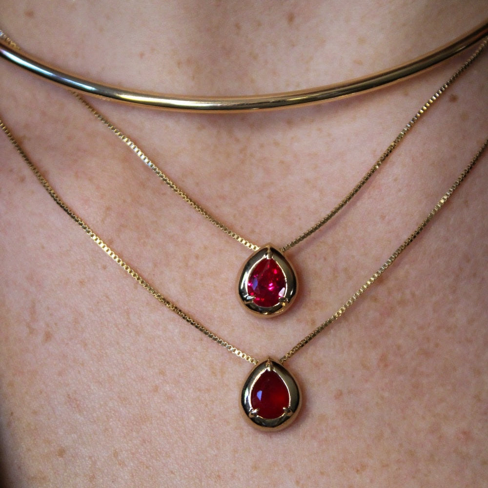 A gold ruby drop July birthstone necklace