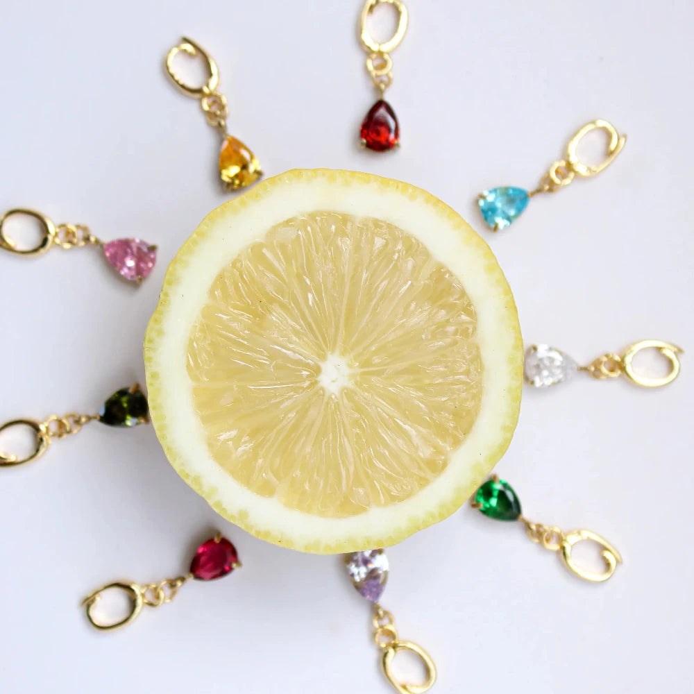 Decorative keychain with lemon slice and colorful beads on a white background