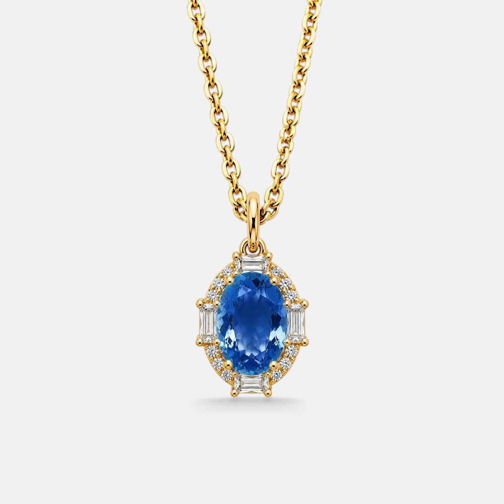 Gold necklace with a blue gemstone pendant on a white background