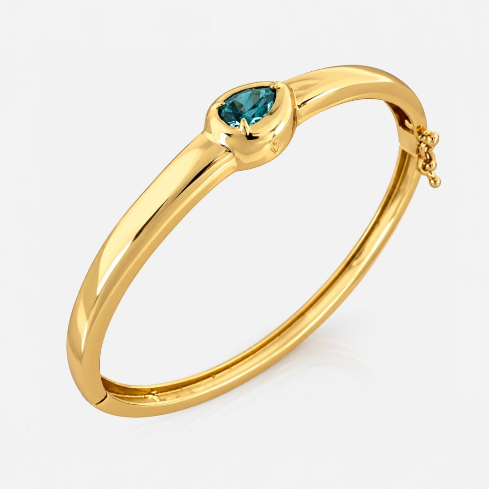 Gold June birthstone bangle with alexandrite coloured pear cut cubic zirconia