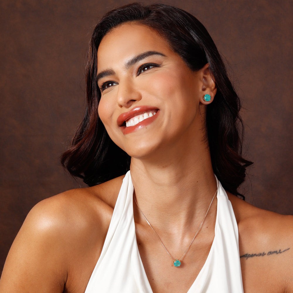 Woman wearing a white halter top against a brown background