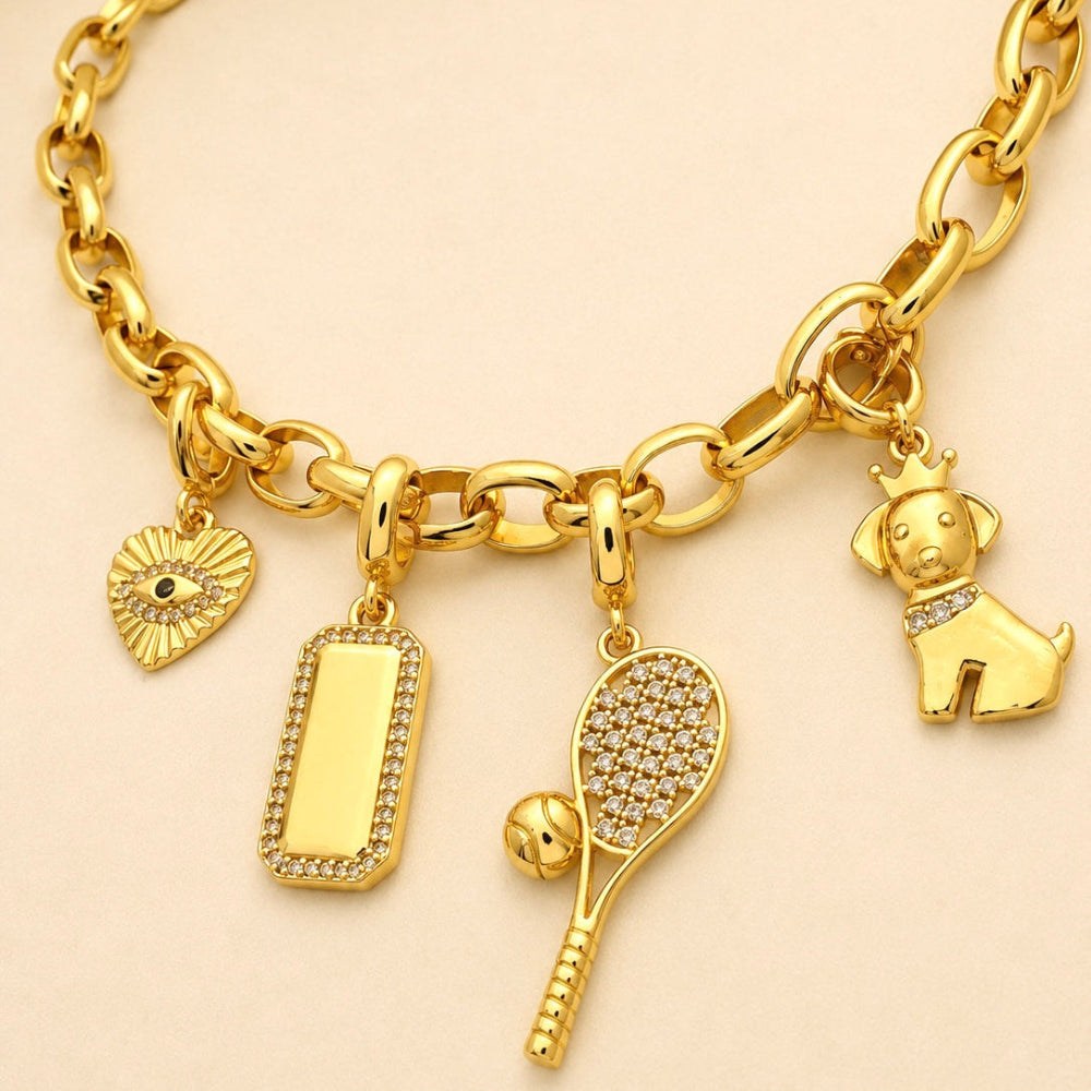 Gold bracelet with various charms on a beige background