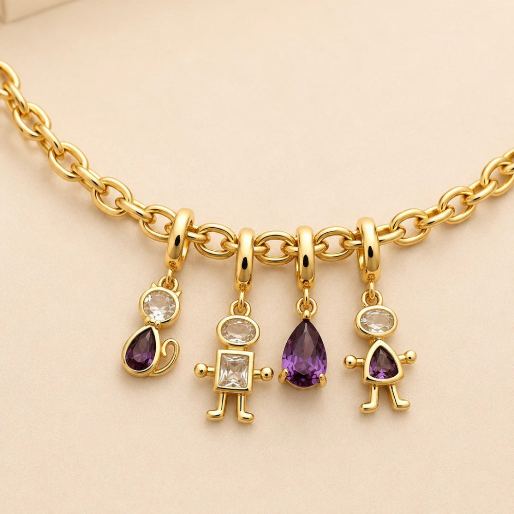 Gold necklace with three unique pendants on a beige background