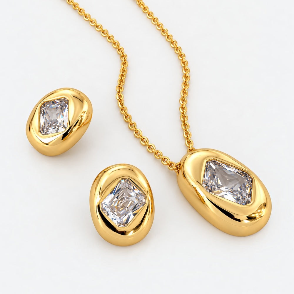 18ct gold-plated brass matching necklace and stud earrings with clear rectangular cubic zirconia stones in sculptural oval settings