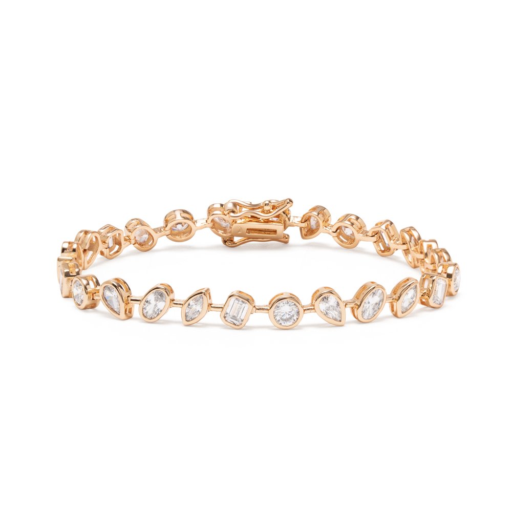 Gold-plated brass Riviera tennis bracelet with clear pear, marquise, round and baguette-shaped cubic zirconia in bezel settings