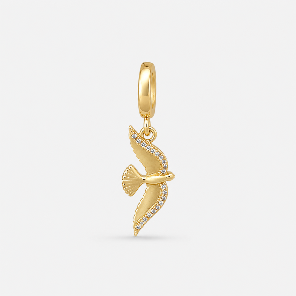 Gold plated dove charm symbolising Holy Spirit close-up