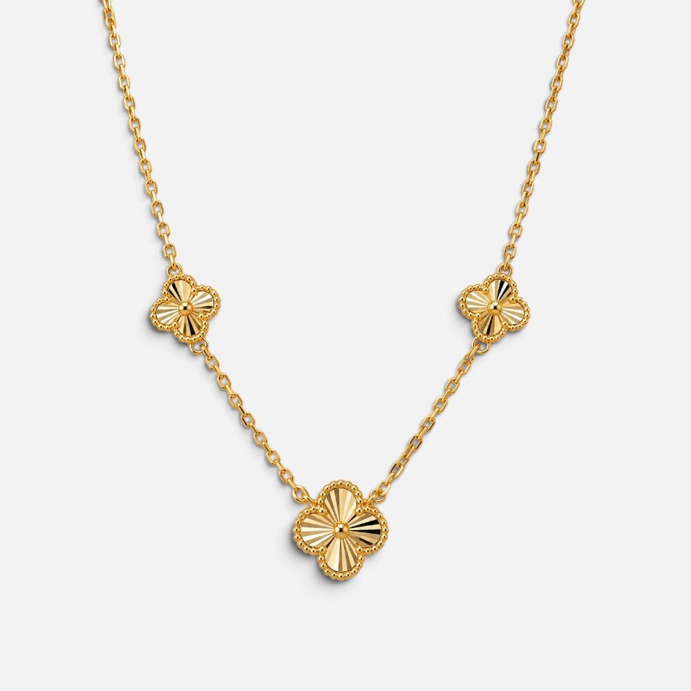 Gold vermeil necklace on sterling silver with three textured four-leaf clover motifs on a fine chain