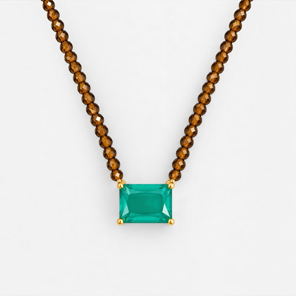 Close-up of rectangular green zirconia pendant and faceted brown jade beads
