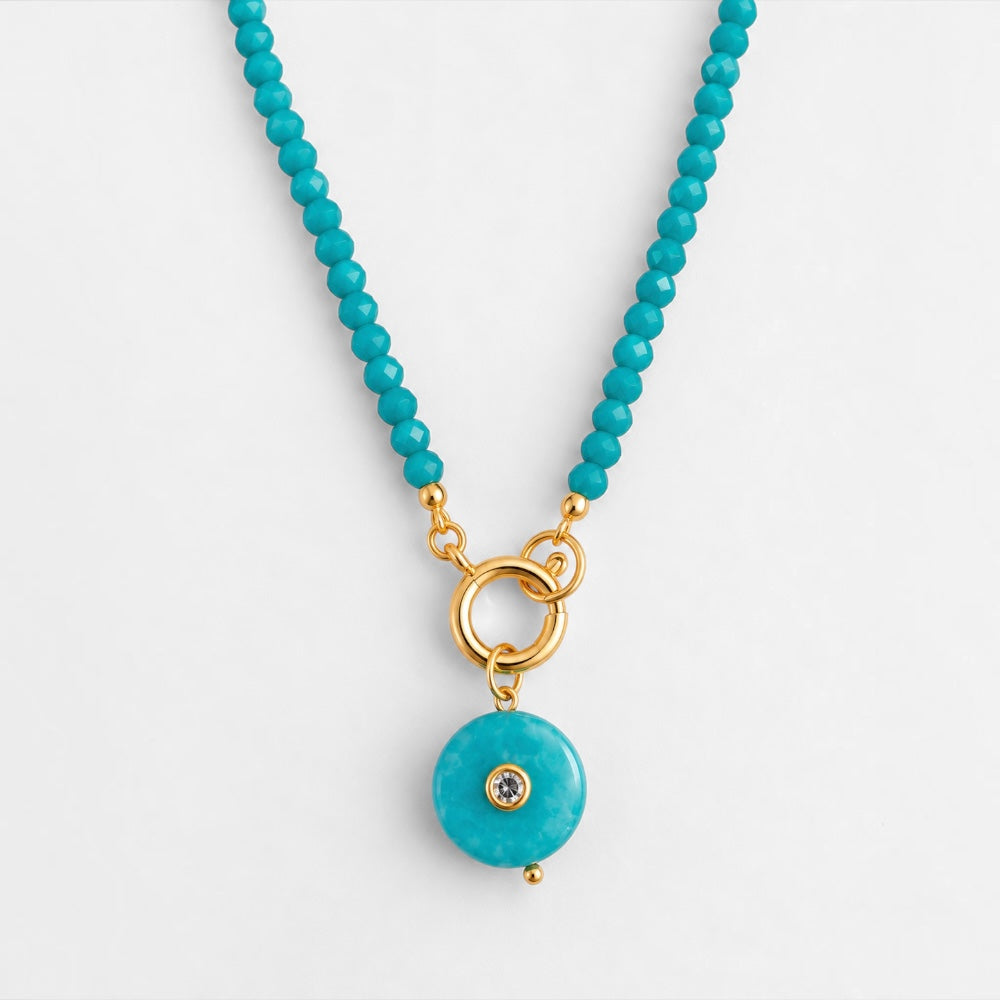 Turquoise-blue jade beaded necklace with round reconstituted turquoise pendant and gold-plated circular clasp