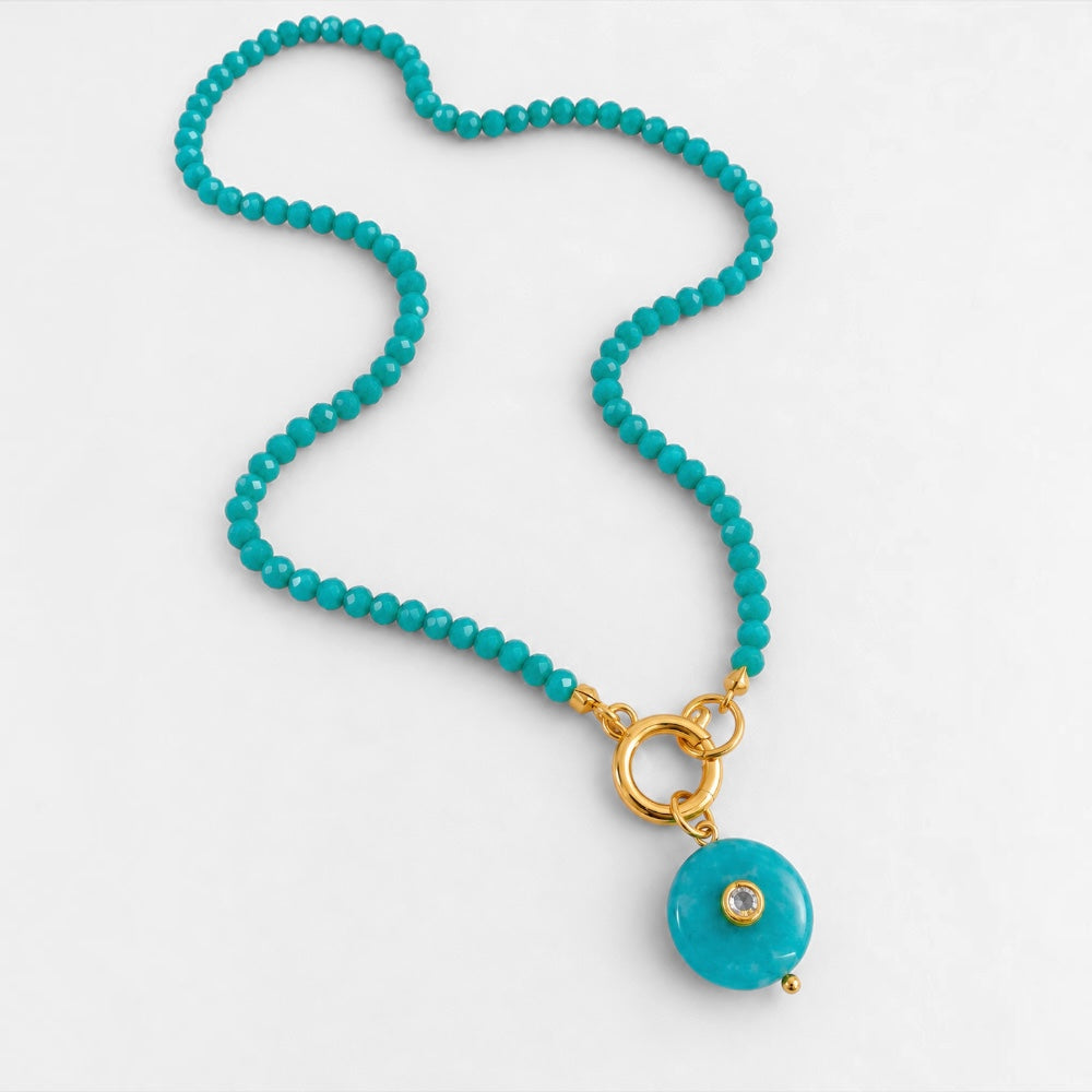 Full view of turquoise-blue jade bead necklace with round reconstituted turquoise pendant and gold-plated detailing