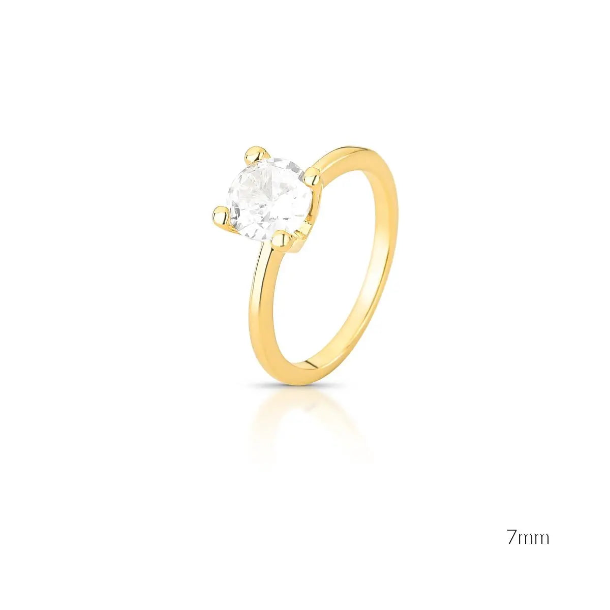 Gold ring with a clear gemstone on a white background