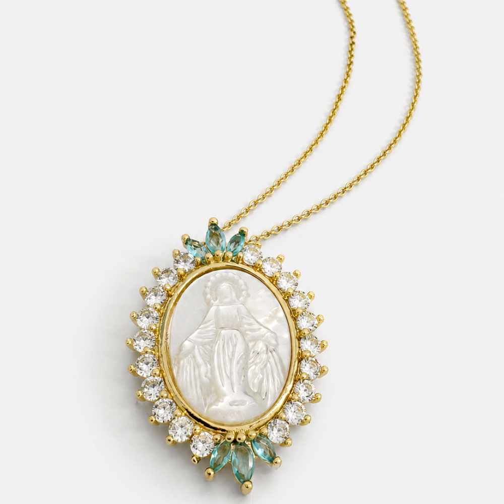 Gold necklace with a pendant featuring a religious figure and gemstones on a white background
