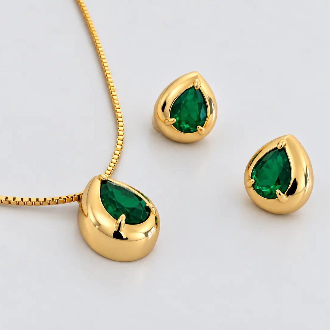 Gold May birthstone jewellery set with emerald green cubic zirconia