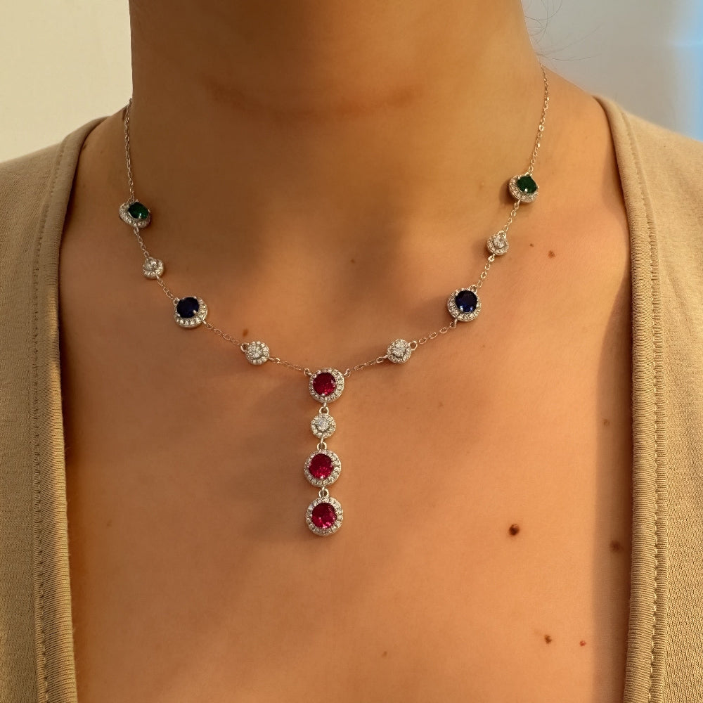 Necklace with gemstones worn by a person, with a blurred background