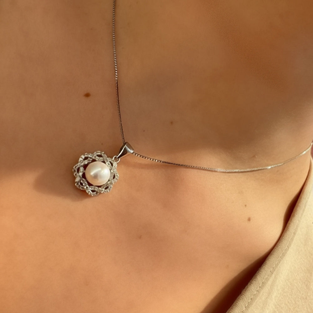Necklace with a pendant worn by a person, with a blurred background