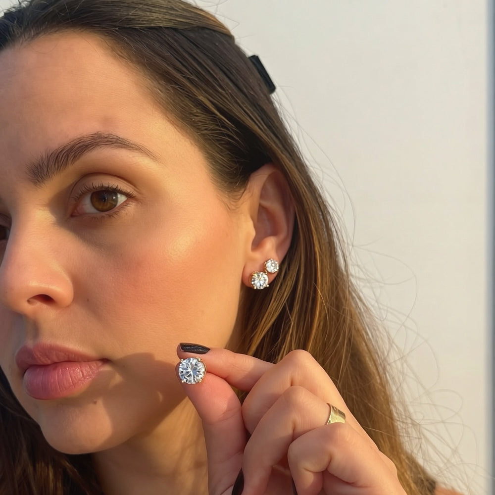 Woman wearing 9mm round cubic zirconia solitaire stud earrings