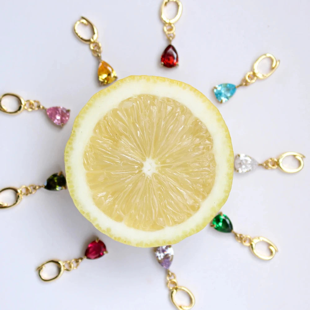 Decorative keychain with lemon slice and colorful beads on a white background