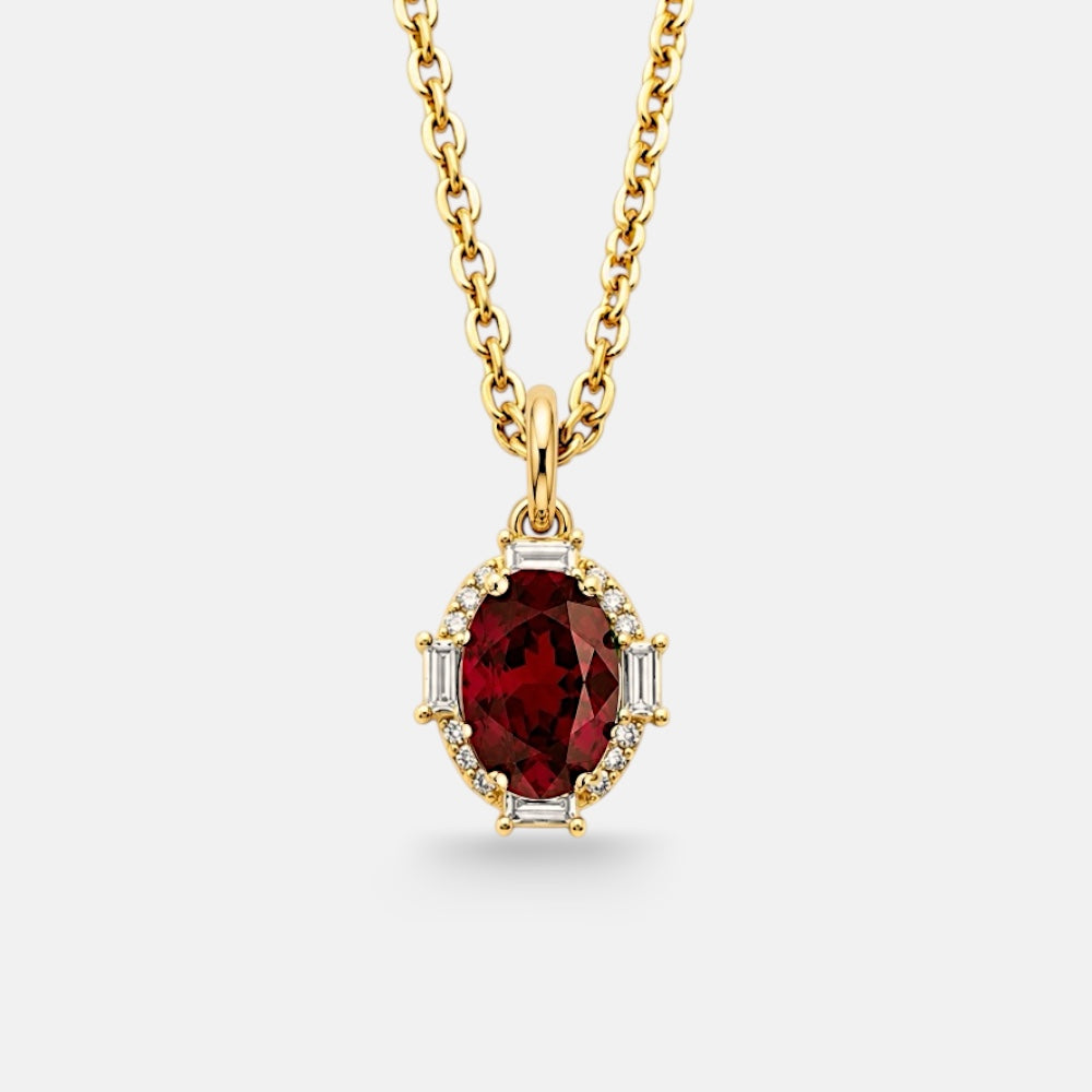 Gold necklace with a red gemstone pendant on a white background
