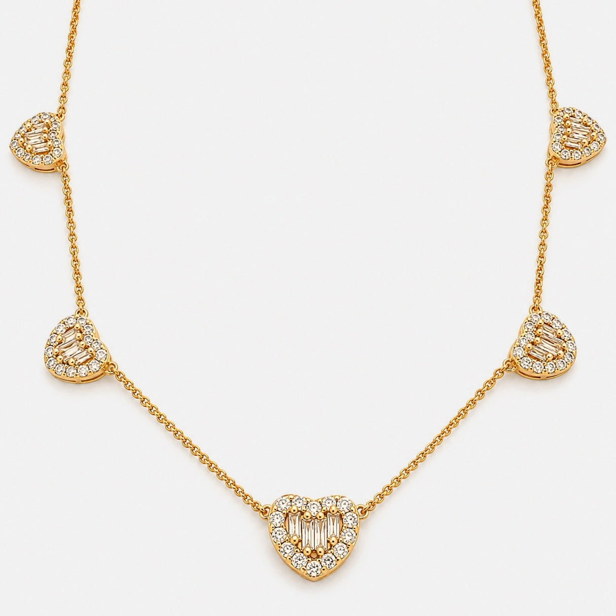 Gold plated necklace with five cubic zirconia heart motifs in baguette and round cuts