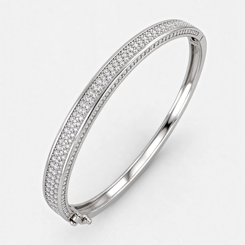 Silver-plated brass hinged bangle with double rows of clear cubic zirconia pavé and a smooth polished divider