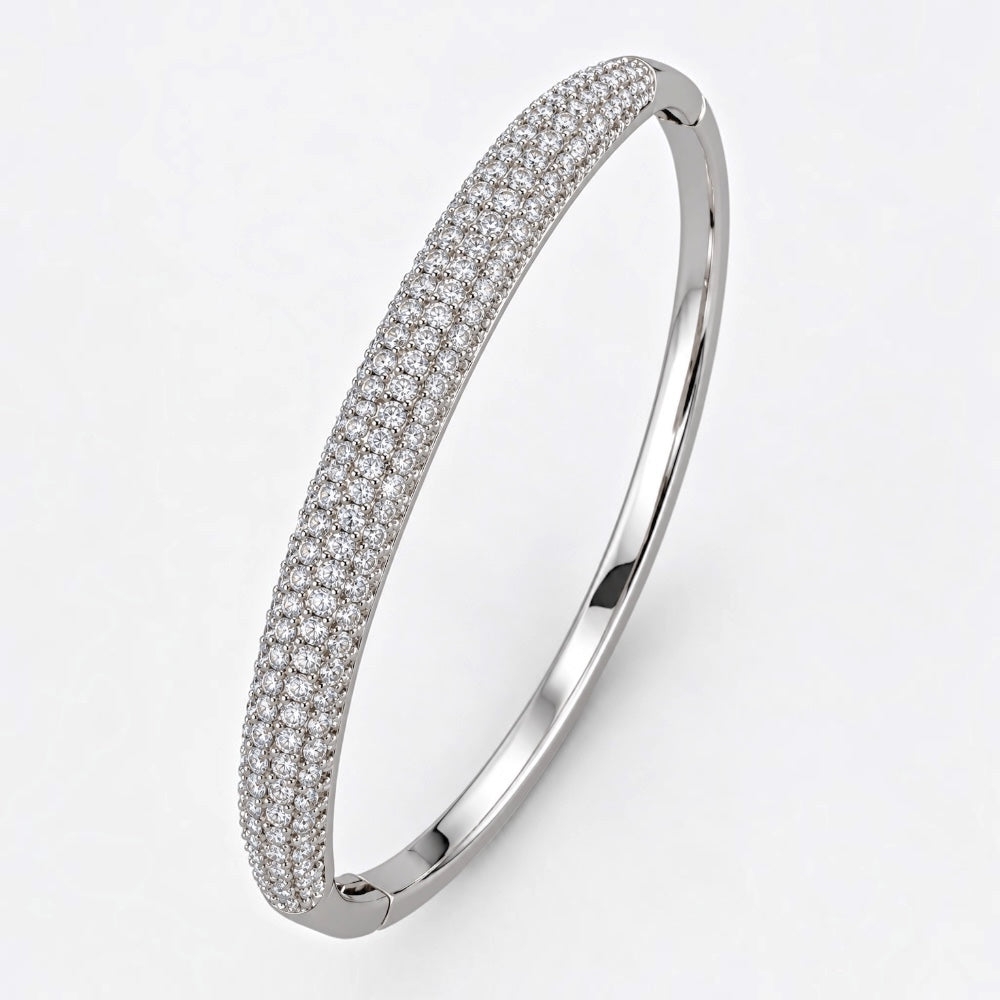 Silver-plated brass hinged bangle with a domed front set with rows of clear cubic zirconia